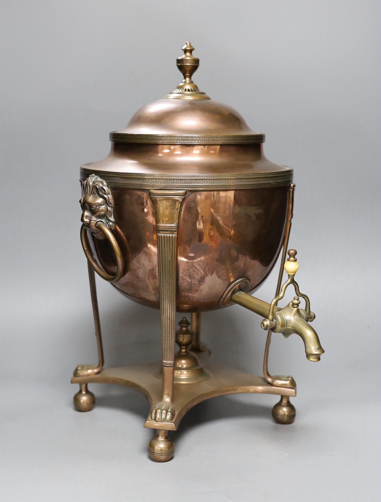 A copper samovar with lion mask handles, brass tap, 45cms high